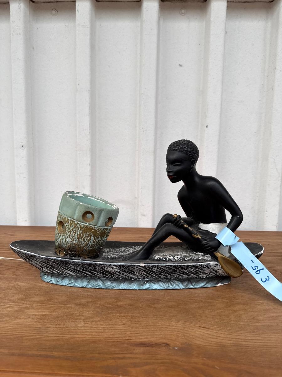 Antique Man in canoe lamp