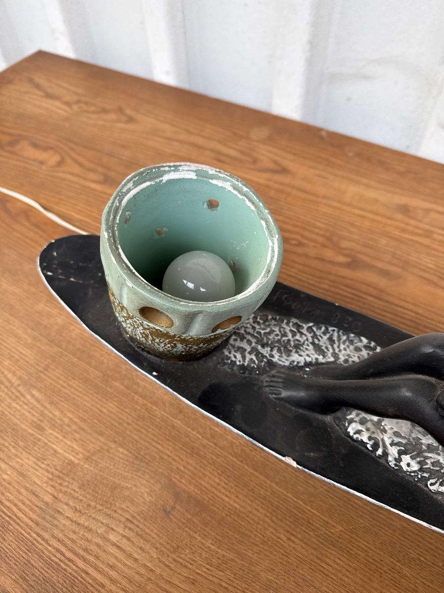 Antique Man in canoe lamp