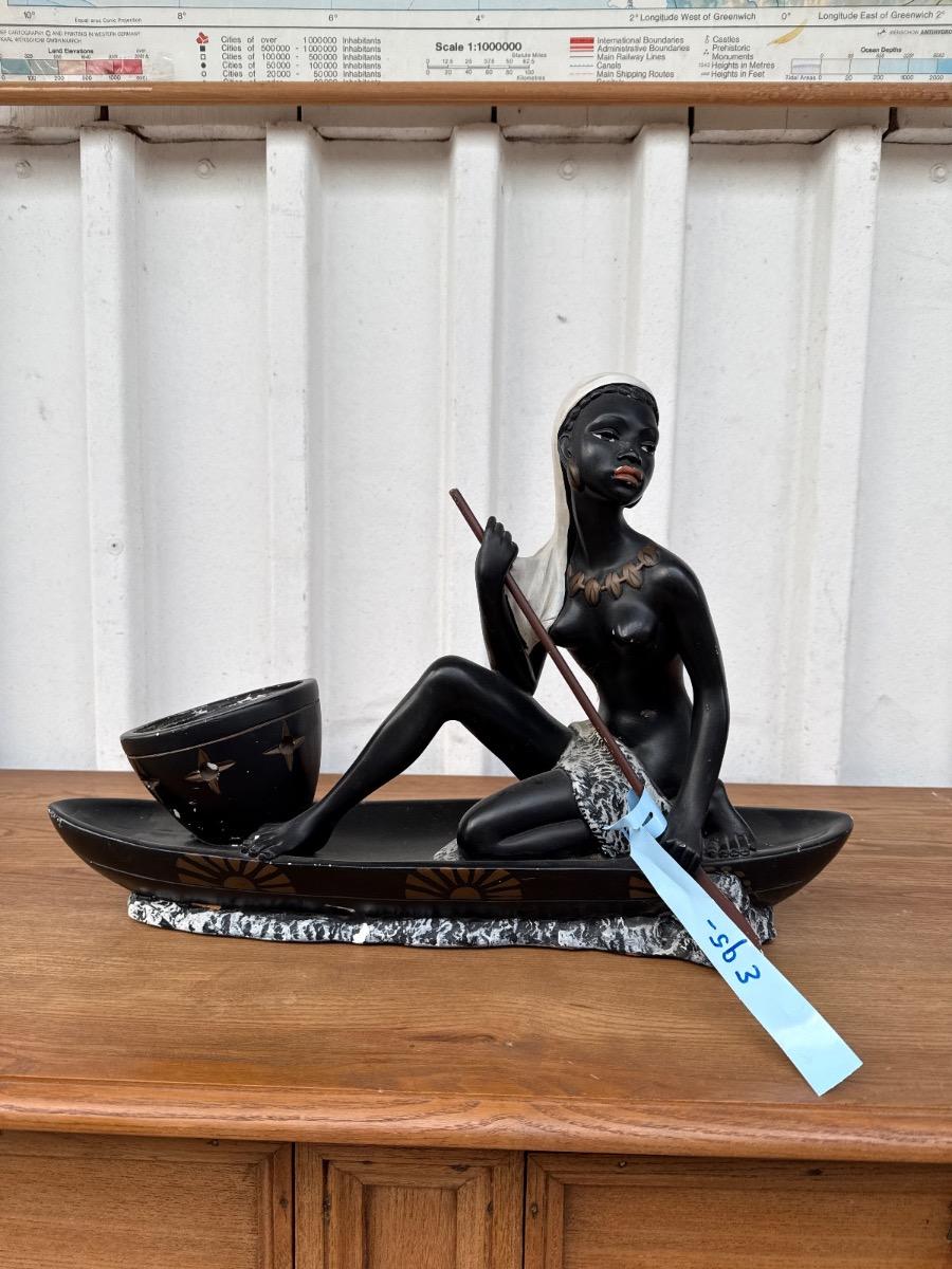 Antique Statue of a woman in a canoe