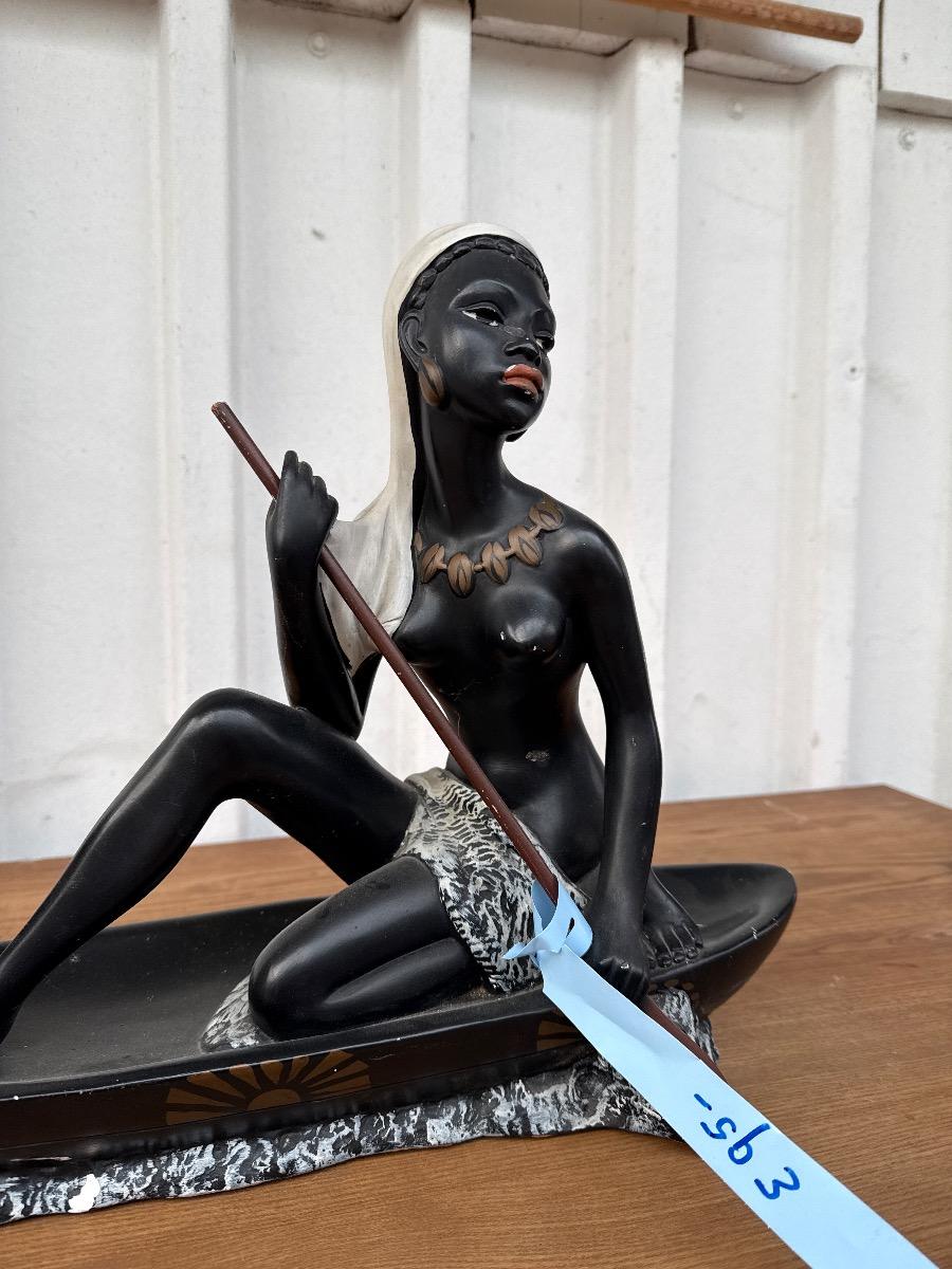 Antique Statue of a woman in a canoe