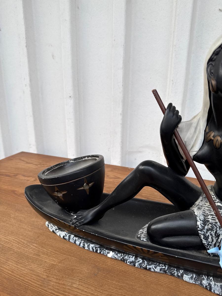 Antique Statue of a woman in a canoe