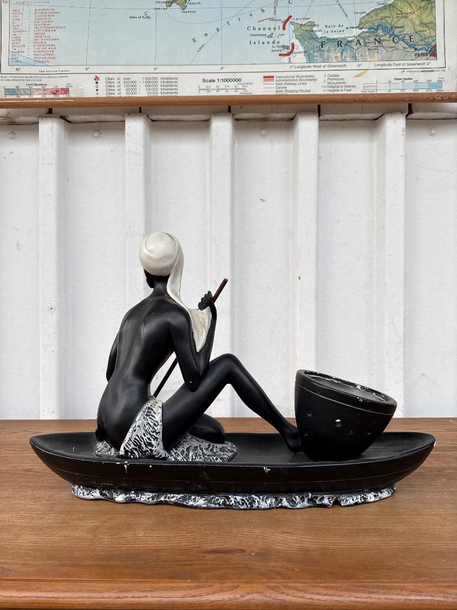 Antique Statue of a woman in a canoe
