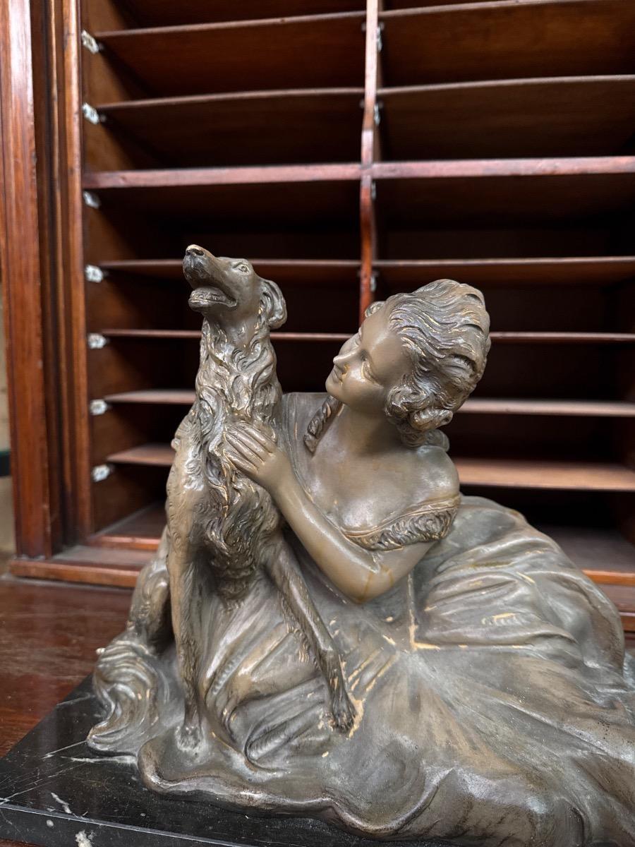 Antique Statue og a reclining woman and a dog