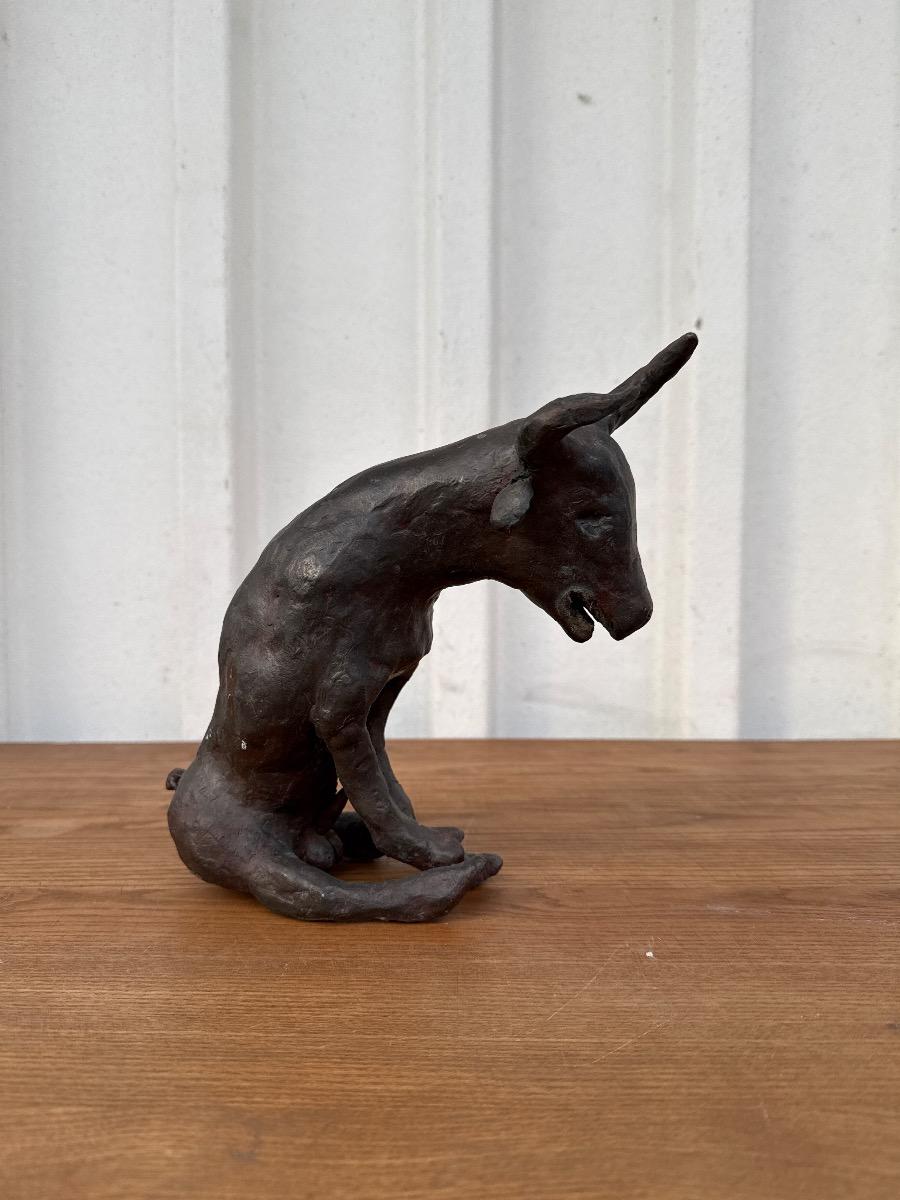 bronze statue of a seated bull