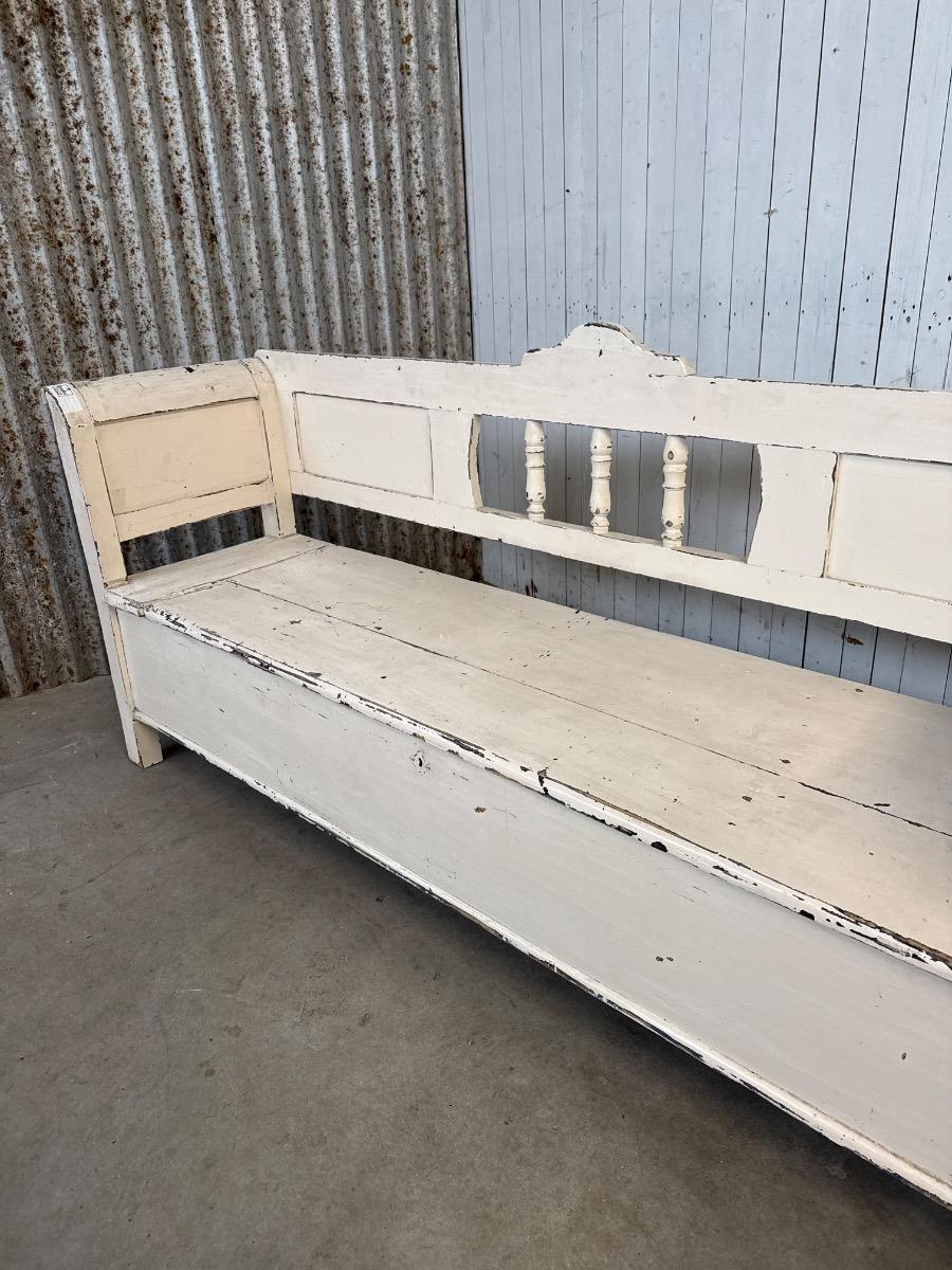 white antique bench with storage space