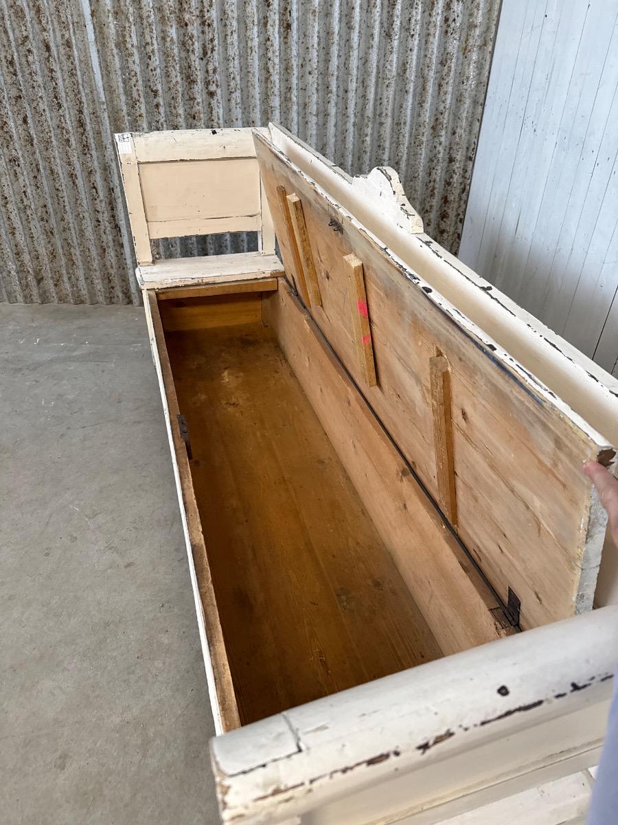 white antique bench with storage space