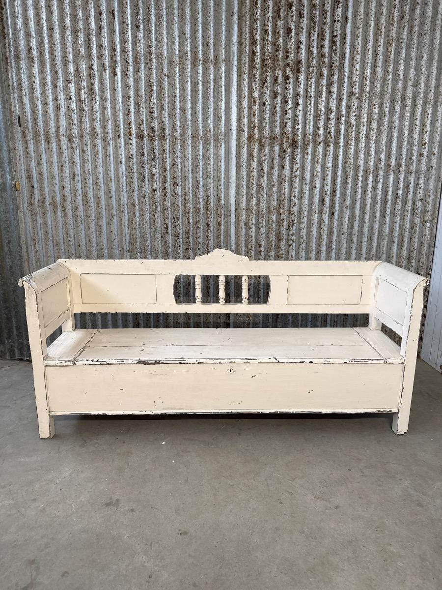 white antique bench with storage space
